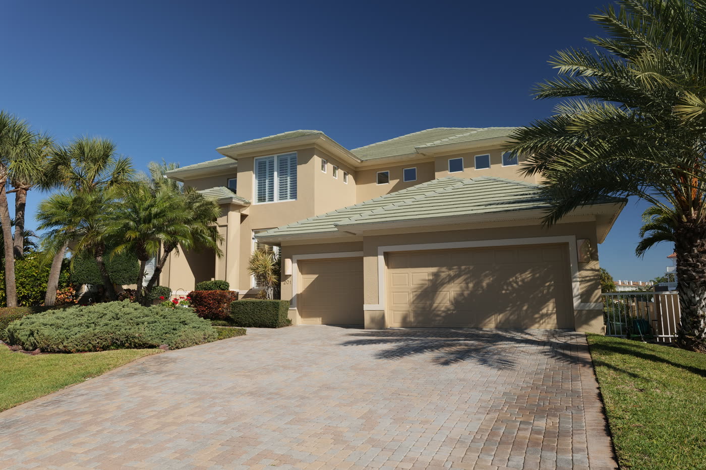 Tan Mediterranean-style Florida home exterior painted by LIME Painting